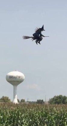 A witch on a broomstick in the sky